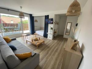 a living room with a couch and a table at Appartement Pour 6 Personne- Residence San Michele in Hossegor