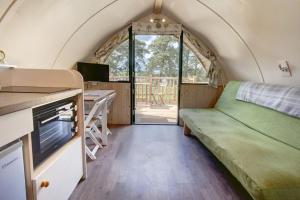 a room with a bed and a desk in a tiny house at Finest Retreats - Wheatleys Glamping in Hexham