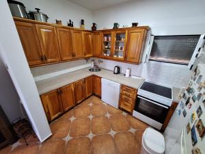 a small kitchen with wooden cabinets at Sunset in Ulcinj