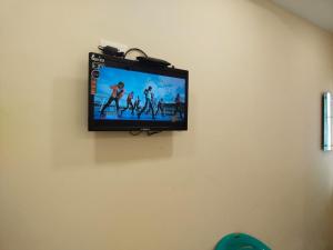 a flat screen tv hanging on a wall at Selvi Residency in Rāmeswaram