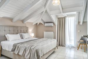 Postel nebo postele na pokoji v ubytování Andromeda Villa