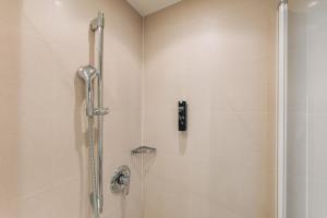 a shower in a bathroom with a glass shower stall at Homaris Corner Hotel in Frankfurt/Main +37 photos