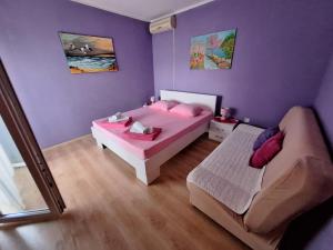 a small bedroom with a bed and a couch at Sunset in Ulcinj