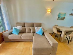 a living room with a couch and a table at Llevant - Apartamento en planta baja con piscina in Arenal d'en Castell