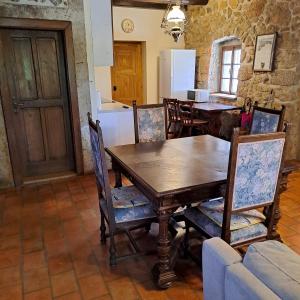 a dining room with a wooden table and chairs at House Green Oasis A4+2 in Dobrinj +22 photos