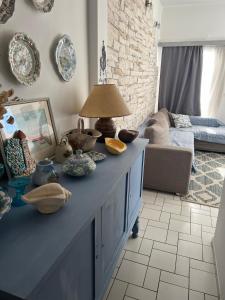 a living room with a table with dishes on it at Lovely sea apartment Amarynthos in Amarinthos