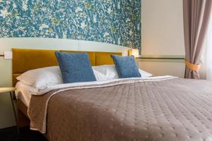 Posteľ alebo postele v izbe v ubytovaní Hotel Arcus Garden