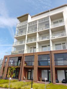 a tall white building with windows on the side of it at Framnäs Suites in Kirkkonummi