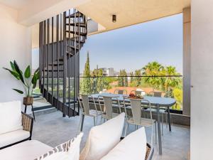 a room with a balcony with a table and chairs at Sanders Evolution 2 Limassol in Limassol +33 photos