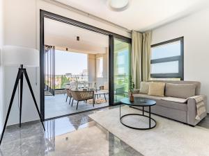 a living room with a couch and a table at Sanders Evolution 2 Limassol in Limassol