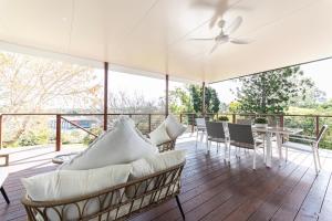 a porch with chairs and a ceiling fan at Urban Getaway Central Cottage in Ipswich