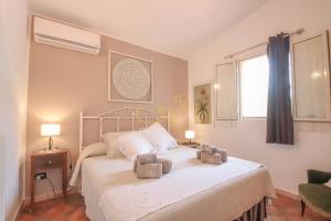 a bedroom with a bed with two towels on it at TD Villa Marinesca Typical Villa with Pool in Polignano a Mare