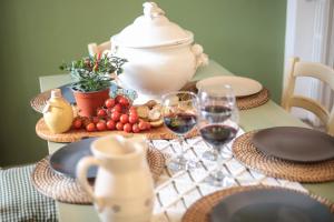 a table with glasses of wine and food on it at TD Villa Marinesca Typical Villa with Pool in Polignano a Mare