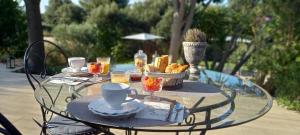 a glass table with a tray of food on it at Au temps pour vous in Le Castellet