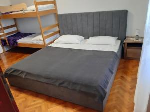 a bed in a room with two bunk beds at Apartman Neda in Sveti Ivan Dobrinjski