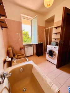 a bathroom with a tub and a washing machine at Villa Marcella - Near 5 Terre - Holiday Apartment in Serralta