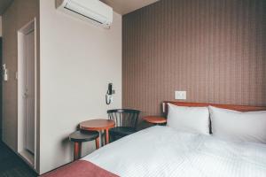 En eller flere senge i et værelse på Hotel Kuretakeso Takayama Ekimae