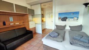 a living room with a bed and a couch at Hund im Glück in Wangerooge