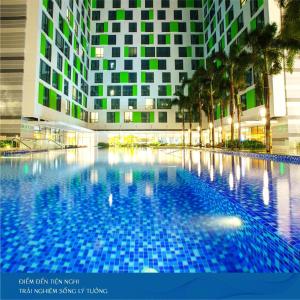 a large swimming pool in front of a building at Republic Airport Apartment Free Swimming Pool in Ho Chi Minh City