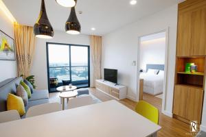 a living room with a white table and a bedroom at Republic Airport Apartment Free Swimming Pool in Ho Chi Minh City