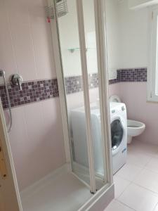 a bathroom with a shower and a washing machine at Domus Mari in Fiuggi