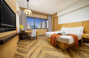 Postel nebo postele na pokoji v ubytování Mellow Orange Hotel