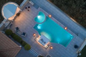 an overhead view of a swimming pool at night at Emerald Villas & Suites - The Finest Hotels Of The World in Agios Nikolaos