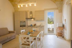 a kitchen and living room with a table and chairs at Villa La Rimunda in Otranto
