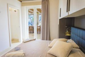 a bedroom with a bed with a view of a patio at Villa La Reimunda in Otranto
