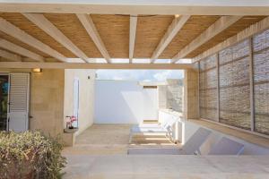 an external view of a house with a wooden ceiling at Villa La Reimunda in Otranto
