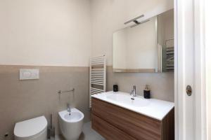 a bathroom with a toilet and a sink and a mirror at Villa La Rimunda in Otranto +97 photos