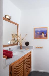a bathroom with a sink and a mirror at Lavender Studio in Patmos
