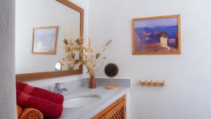 a bathroom with a sink and a mirror at Lavender Studio in Patmos