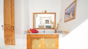 a bathroom with a sink and a mirror at Lavender Studio in Patmos