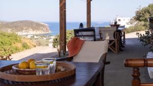 a wooden table with a bowl of fruit on a table at Lavender Studio in Patmos