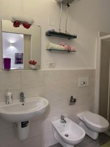 a bathroom with a sink and a toilet and a mirror at La Cattedrale in Bisceglie