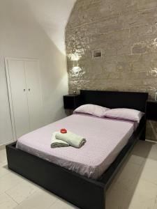 a bedroom with a bed with two towels on it at La Cattedrale in Bisceglie