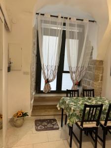 a dining room with a table and a window at La Cattedrale in Bisceglie +22 photos