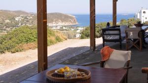 a table with a bowl of fruit on top of a balcony at Lavender Studio in Patmos