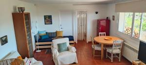 a living room with a table and a dining room at Ànima del Garraf in Sitges