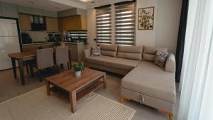 a living room with a couch and a table at - Meta Homes - in Kemer