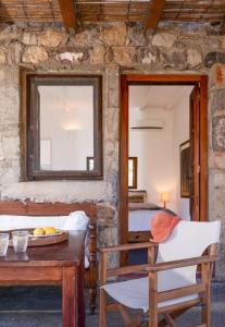 a room with a table and a bed and a mirror at Lavender Studio in Patmos