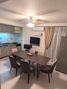 a kitchen and dining room with a table and chairs at Space Noa201 in Tokyo
