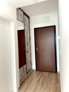 an empty room with a door and a wooden floor at Blue Sutomore in Brca