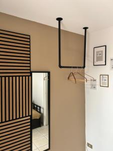 a mirror hangs on the wall next to a room at B&B Crisalide in Putignano +17 photos