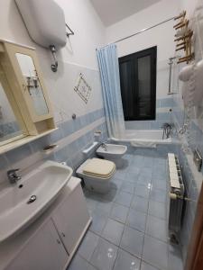 a bathroom with a toilet and a sink at Casa di Eugenia in Loceri