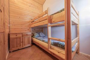a bedroom with two bunk beds in a cabin at Domki letniskowe Ranczo in Darłowo +48 photos