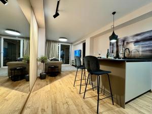 a kitchen and living room with a bar and chairs at Suite Y in Cullera