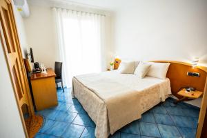 a hotel room with a bed and a television at Il Principe Resort in Agerola