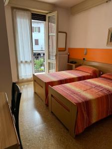 Postel nebo postele na pokoji v ubytování Hotel Garnì Capinera